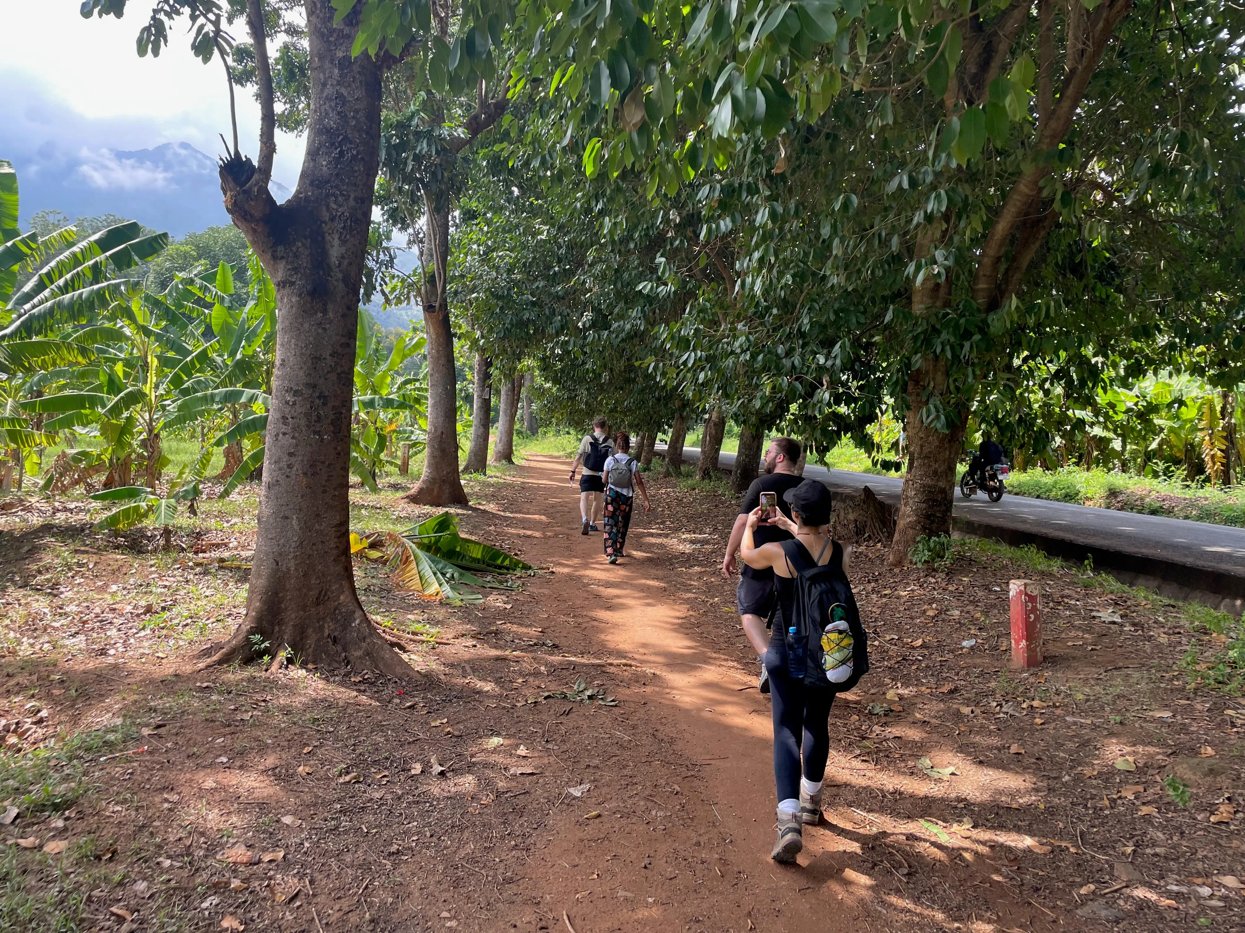 Travellers walking toward Choma Waterfalls in the Morogoro mountains
