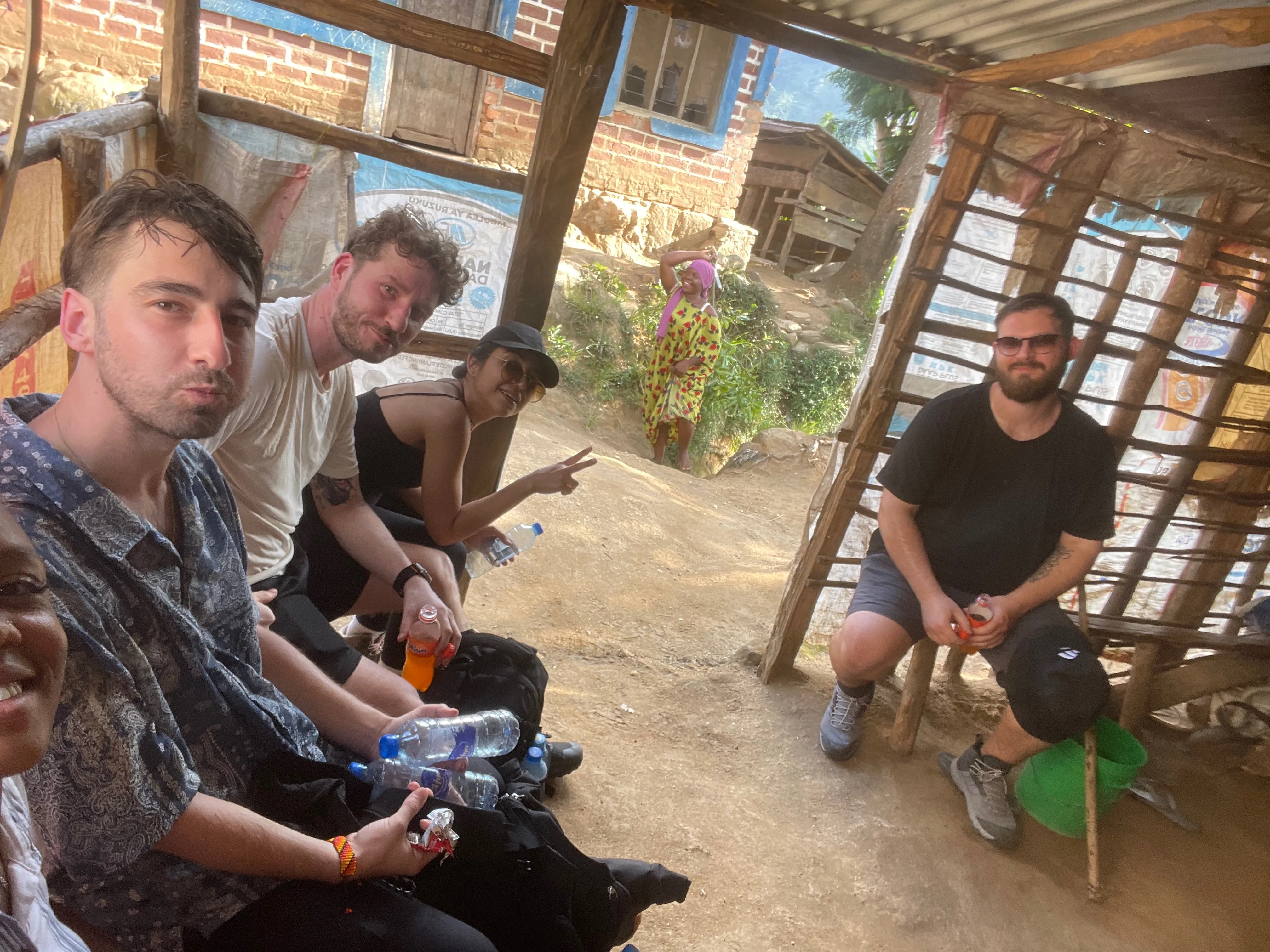 Travellers and local hosts sharing a relaxed village moment