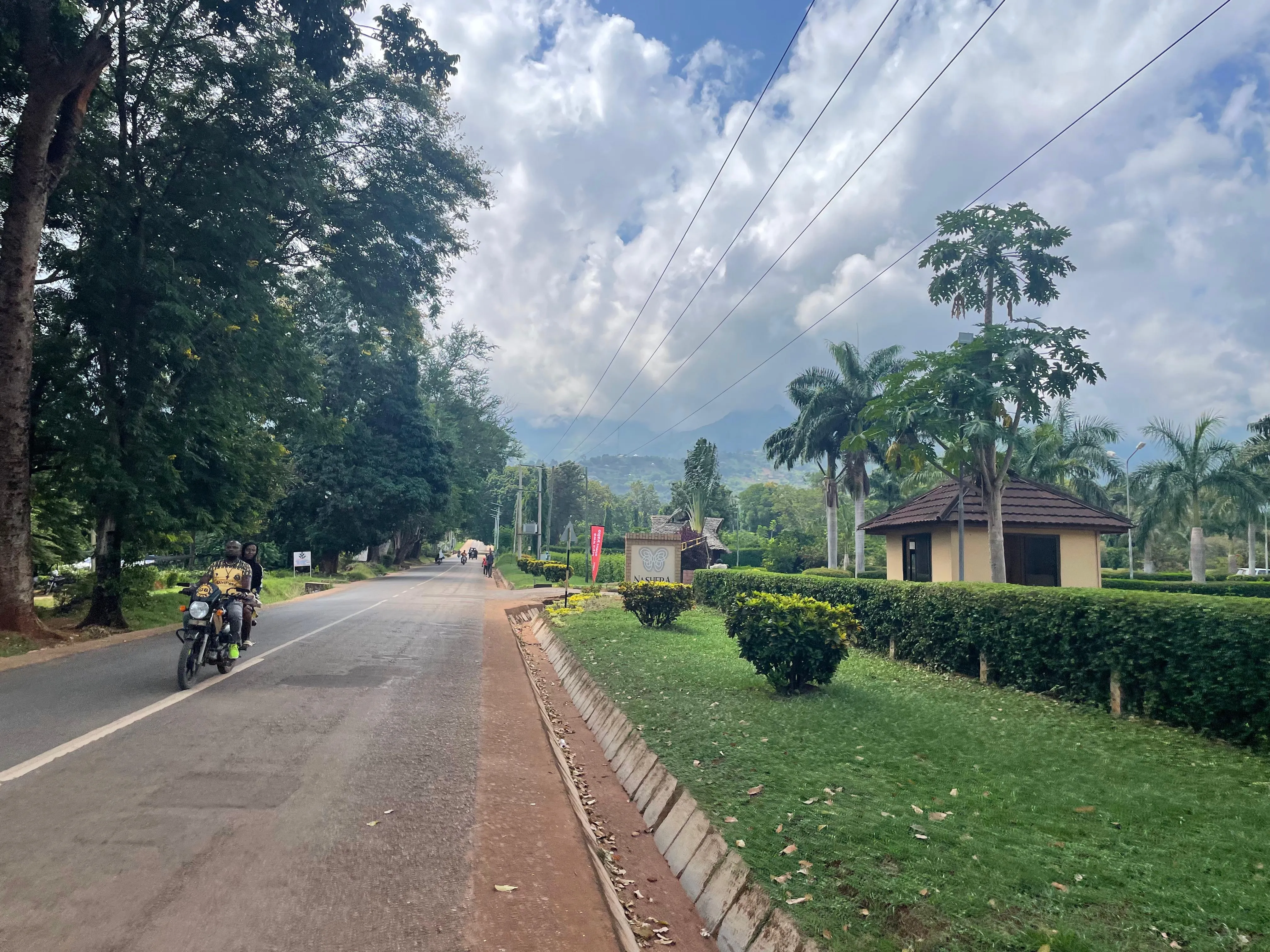 A Morogoro road with green mountains rising behind the city