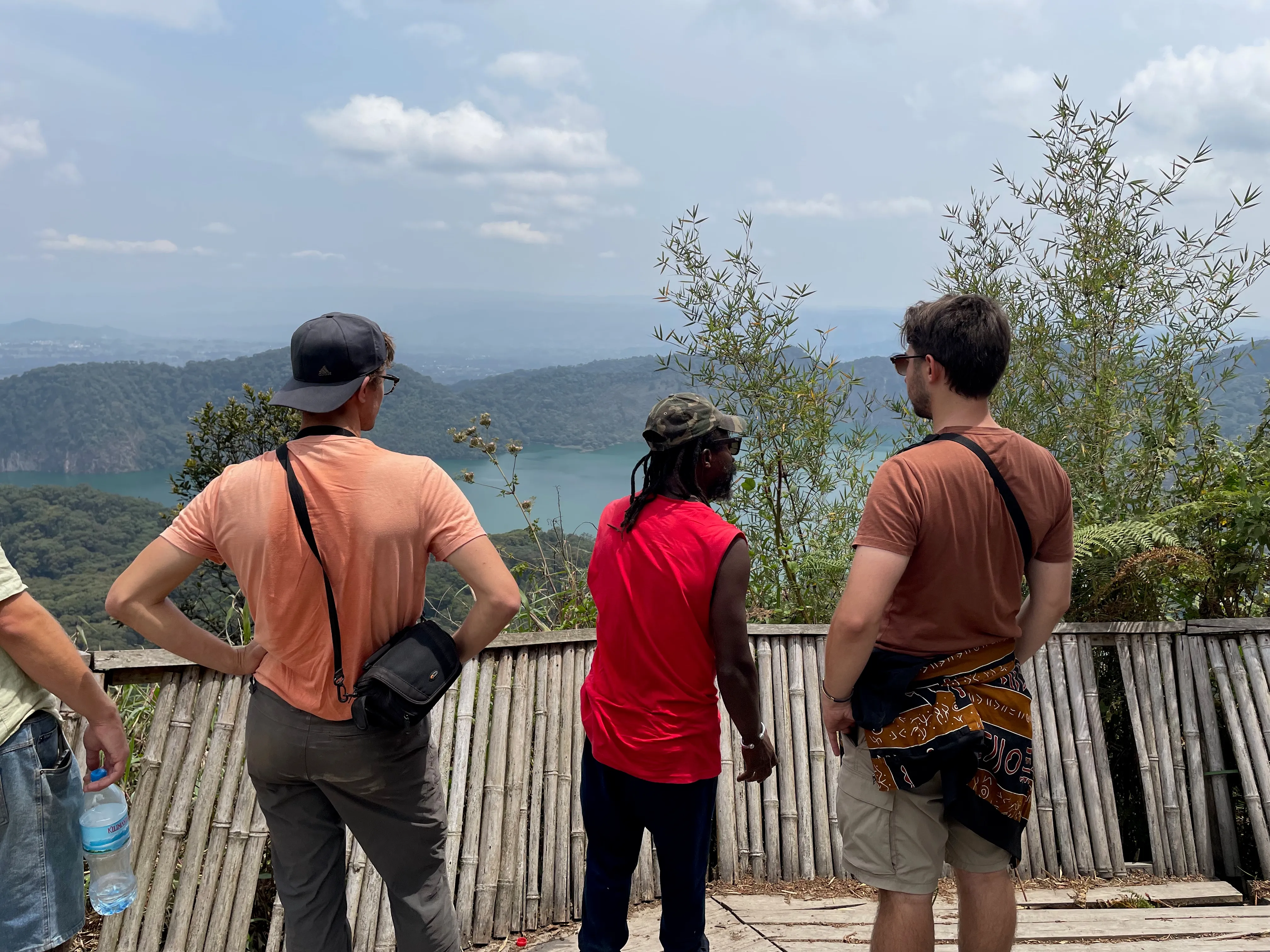 Two travellers looking across Lake Ngozi from the viewpoint