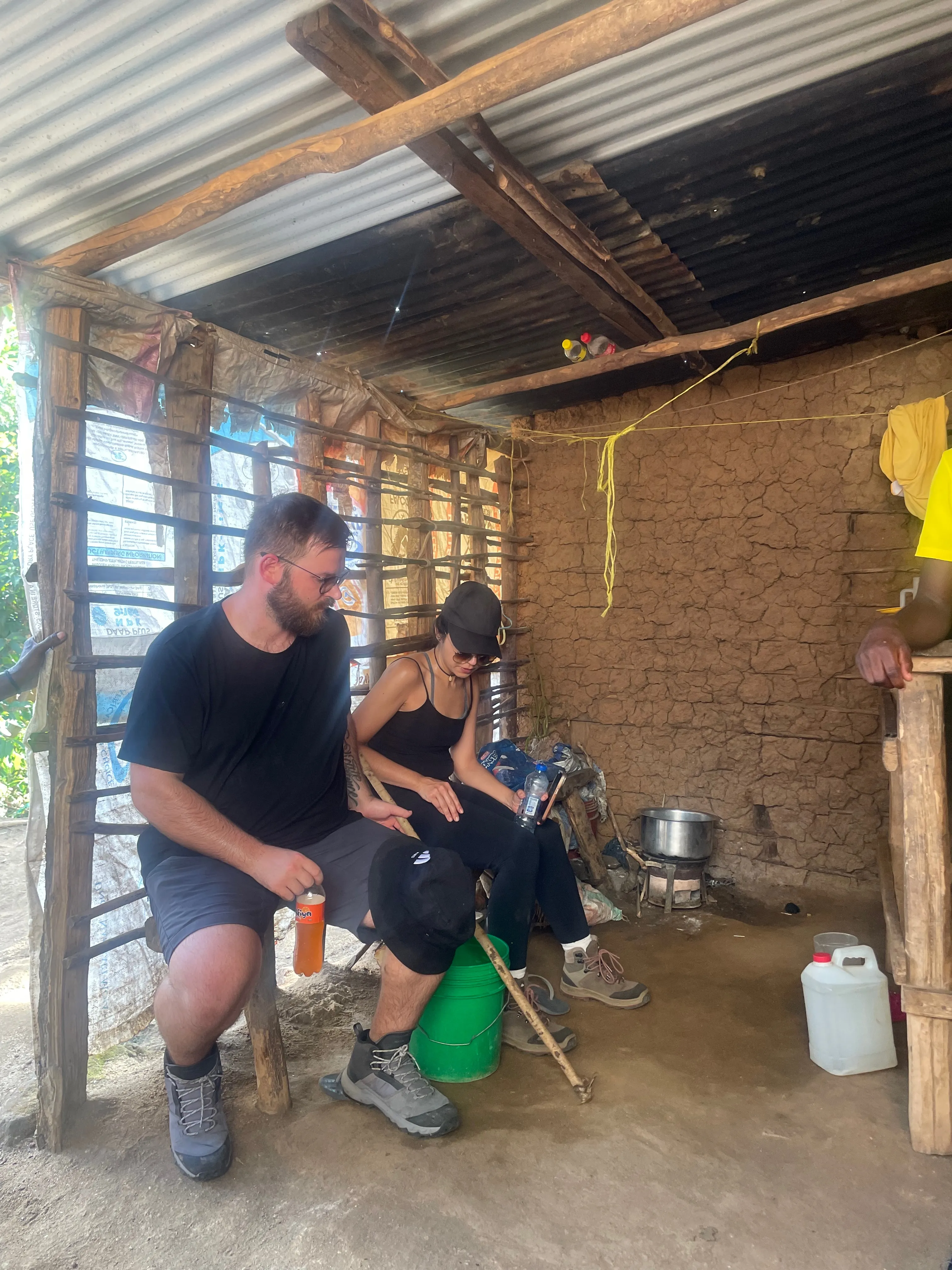 Travellers sharing time inside a local home near Choma Waterfalls